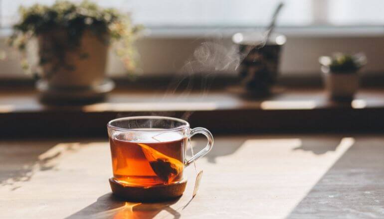 black tea in clear cup on counter