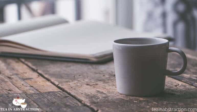 cup of tea next to a book