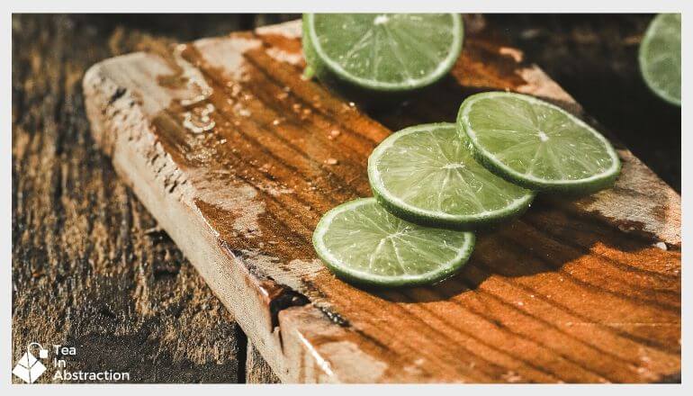 slices of fresh lime on a wooden cutting board