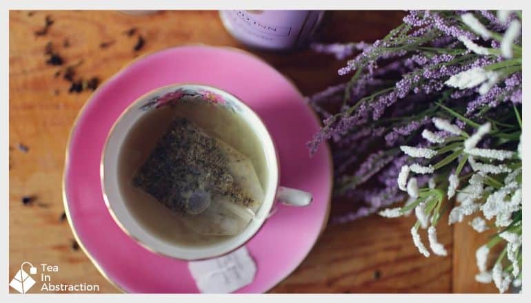Cup of lavender tea with fresh lavender next to it