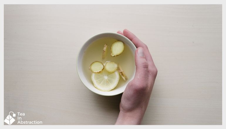 lemon and ginger tea in a white cup 