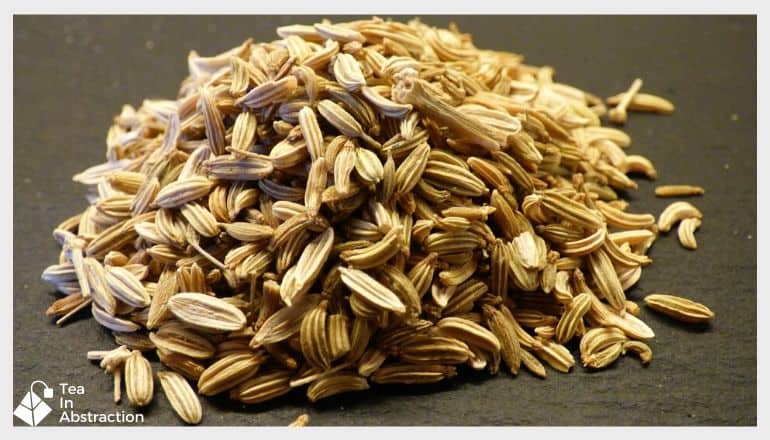 a pile of fennel seeds on a brown table