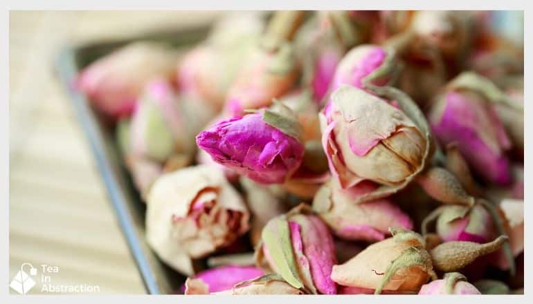 dried pink rose bubs on a silver tray