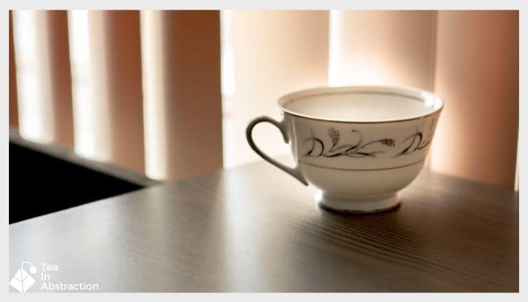 cup of tea on a table in front of a window