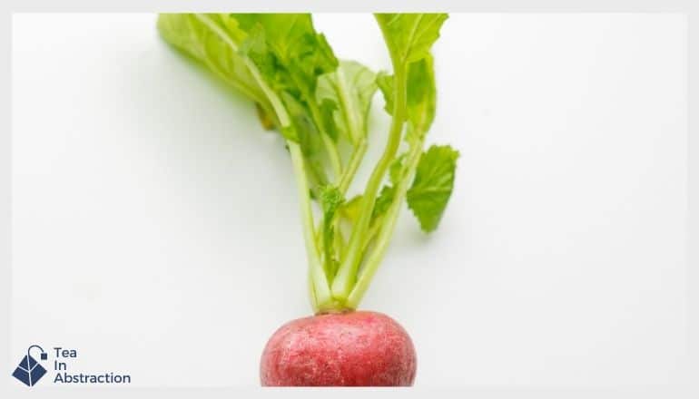 radish with greens still attached on a white table